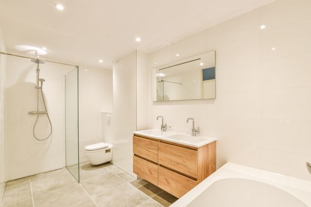 Millennials favor minimalistic bathroom designs, focusing on decluttering, streamlined storage, simple color palettes, and modern fixtures to create a clean, open space.